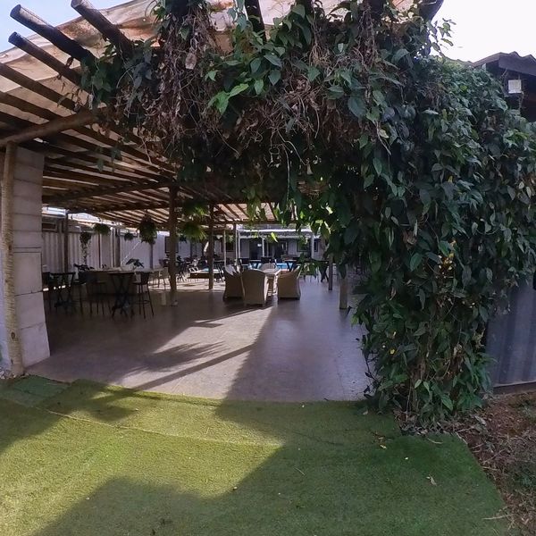 Entrada da Villa Kubitschek sob o pergolado coberto de trepadeiras
